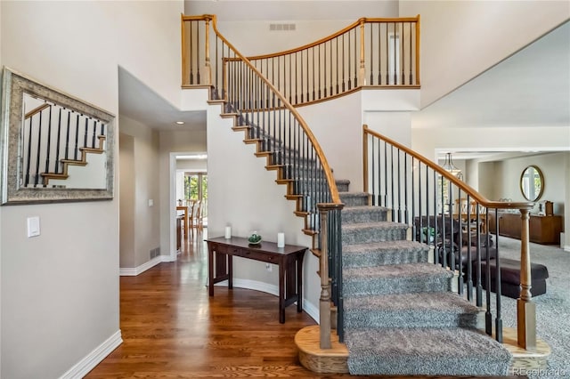2154 S Parfet Dr, Lakewood, CO 80227 - stairs featuring wood finished floors, a towering ceiling, and baseboards