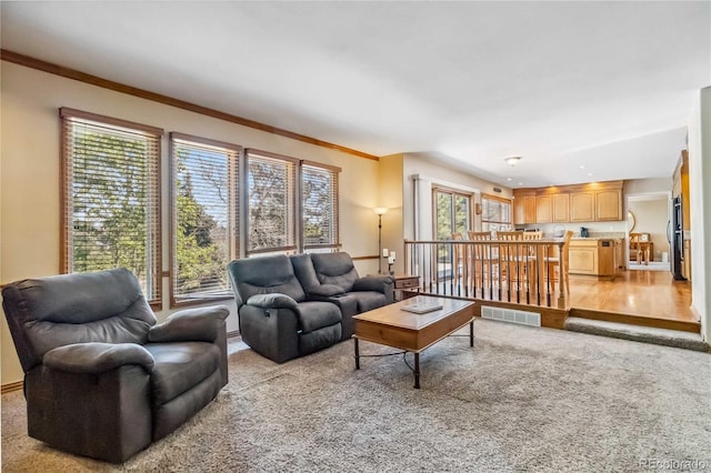 2154 S Parfet Dr, Lakewood, CO 80227 - living room featuring light colored carpet, ornamental molding, and baseboards