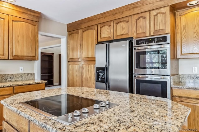 2154 S Parfet Dr, Lakewood, CO 80227 - kitchen with stainless steel appliances, light stone countertops, and brown cabinets