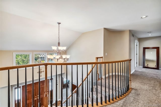 2154 S Parfet Dr, Lakewood, CO 80227 - hallway featuring a chandelier, an upstairs landing, carpet, baseboards, and vaulted ceiling