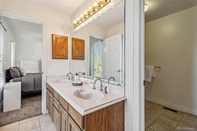 2154 S Parfet Dr, Lakewood, CO 80227 - bathroom with tile patterned flooring, double vanity, and baseboards