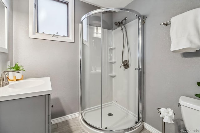 2154 S Parfet Dr, Lakewood, CO 80227 - bathroom with a stall shower, baseboards, and vanity