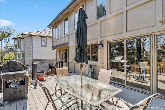 2154 S Parfet Dr, Lakewood, CO 80227 - wooden deck with outdoor dining space and a grill