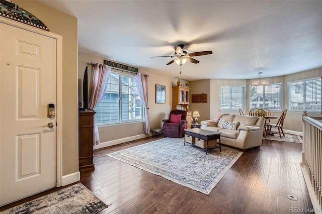 living room featuring a wealth of natural light, baseboards, and dark wood-style flooring