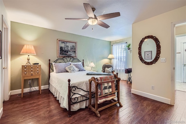 bedroom with a ceiling fan, baseboards, and dark wood-style flooring