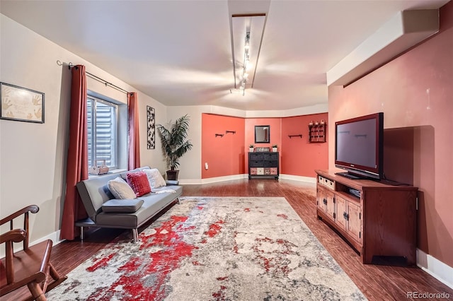 living area with dark wood finished floors and baseboards