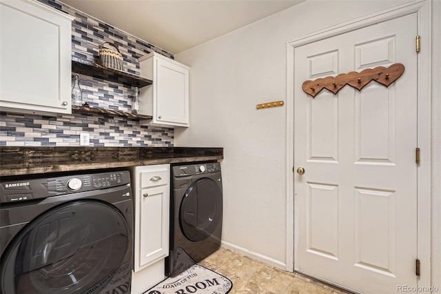 laundry area with cabinet space, independent washer and dryer, and baseboards