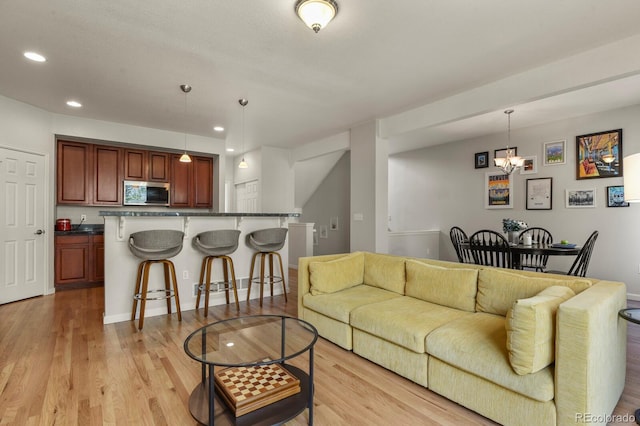 living area with light wood-style floors and recessed lighting