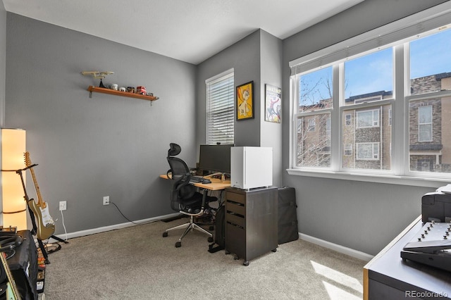 office with baseboards and light carpet