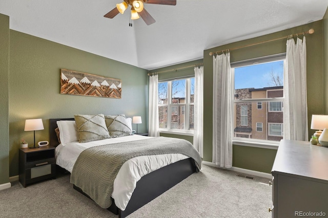 bedroom with carpet, baseboards, lofted ceiling, and a ceiling fan