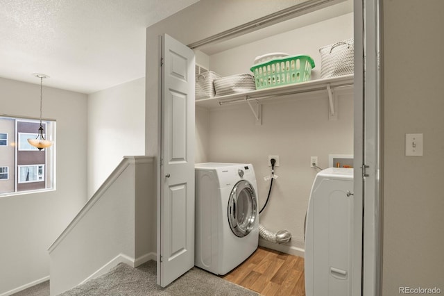 laundry area featuring light wood-style flooring, baseboards, and washer and dryer