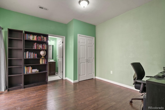 office area featuring dark wood-type flooring and baseboards