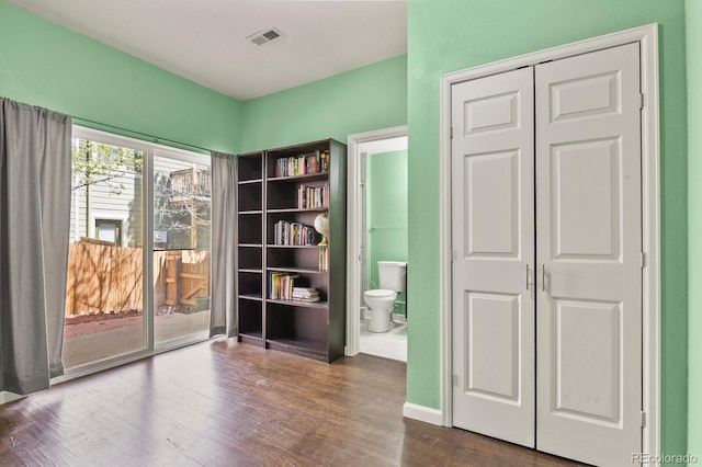 unfurnished room featuring dark wood-type flooring