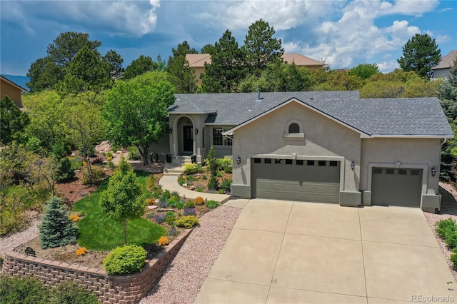40 Wuthering Heights Dr, Colorado Springs, CO 80921 - view of front of property with stucco siding, driveway, a garage, and roof with shingles