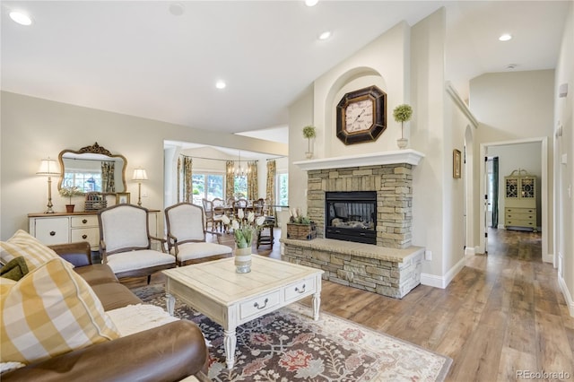 40 Wuthering Heights Dr, Colorado Springs, CO 80921 - living room with light wood finished floors, a stone fireplace, baseboards, high vaulted ceiling, and recessed lighting