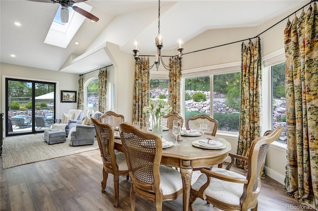 40 Wuthering Heights Dr, Colorado Springs, CO 80921 - dining area featuring vaulted ceiling, a chandelier, wood finished floors, a skylight, and recessed lighting