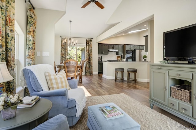 40 Wuthering Heights Dr, Colorado Springs, CO 80921 - living room with a chandelier, a ceiling fan, wood finished floors, high vaulted ceiling, and baseboards