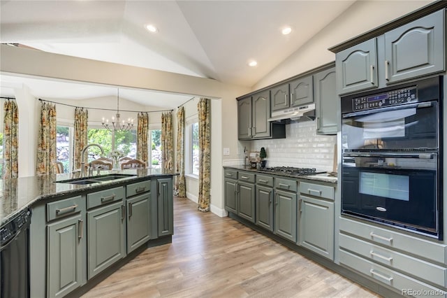 40 Wuthering Heights Dr, Colorado Springs, CO 80921 - kitchen featuring vaulted ceiling, black appliances, a sink, a chandelier, and tasteful backsplash