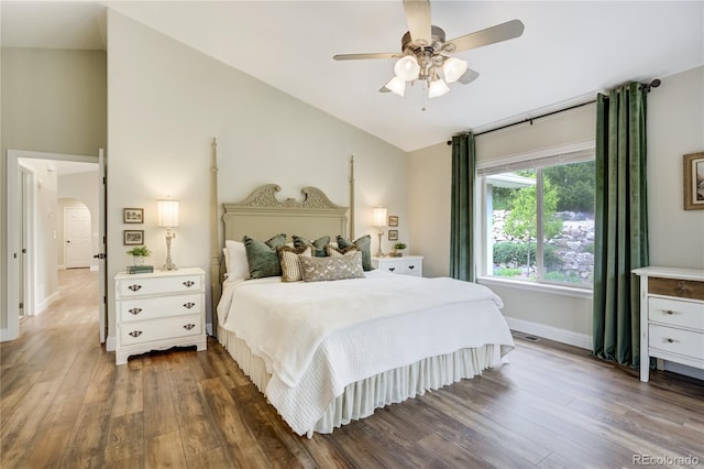 40 Wuthering Heights Dr, Colorado Springs, CO 80921 - bedroom featuring lofted ceiling, wood finished floors, baseboards, arched walkways, and ceiling fan