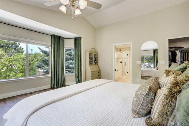 40 Wuthering Heights Dr, Colorado Springs, CO 80921 - bedroom with lofted ceiling, wood finished floors, arched walkways, a walk in closet, and baseboards