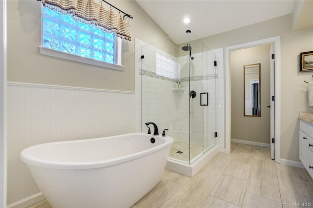 40 Wuthering Heights Dr, Colorado Springs, CO 80921 - full bathroom featuring a shower stall, a freestanding bath, vanity, and a wainscoted wall