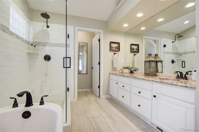 40 Wuthering Heights Dr, Colorado Springs, CO 80921 - full bathroom featuring a stall shower, double vanity, recessed lighting, a bathtub, and baseboards