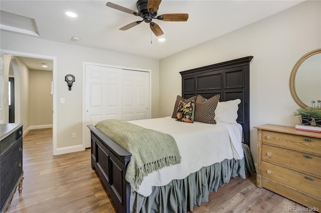 40 Wuthering Heights Dr, Colorado Springs, CO 80921 - bedroom featuring wood finished floors, baseboards, a closet, arched walkways, and recessed lighting