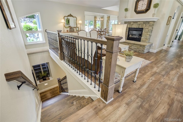 40 Wuthering Heights Dr, Colorado Springs, CO 80921 - staircase with plenty of natural light, wood finished floors, a stone fireplace, and baseboards