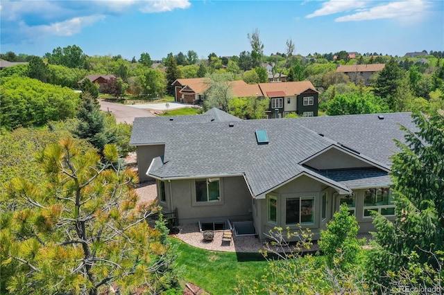 40 Wuthering Heights Dr, Colorado Springs, CO 80921 - back of house featuring a shingled roof and stucco siding