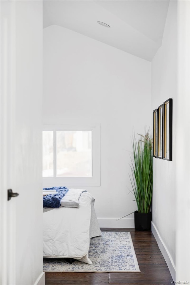 bedroom with dark hardwood / wood-style flooring and vaulted ceiling