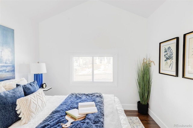 bedroom with dark wood-type flooring and high vaulted ceiling