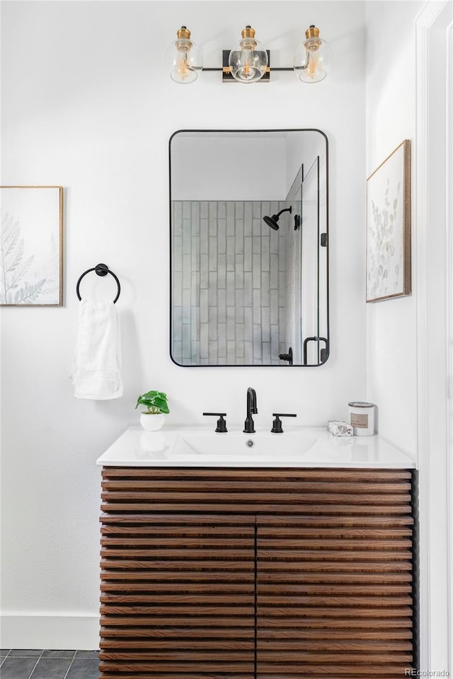 bathroom featuring vanity, tile patterned floors, and walk in shower