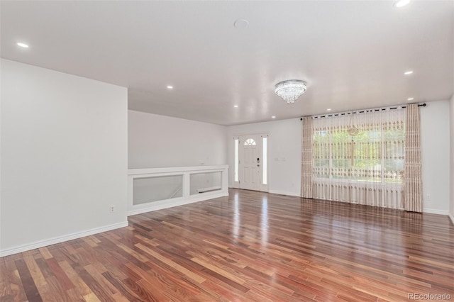 5403 Odessa St, Denver, CO 80249 - unfurnished living room with recessed lighting, wood finished floors, and baseboards