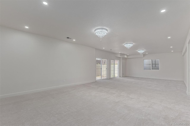 5403 Odessa St, Denver, CO 80249 - empty room with recessed lighting, light carpet, baseboards, and a chandelier