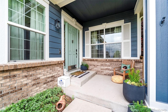 view of exterior entry with covered porch