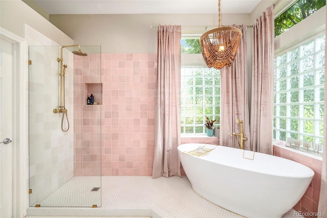 bathroom with tile walls and plus walk in shower