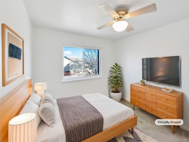 bedroom featuring light carpet and ceiling fan