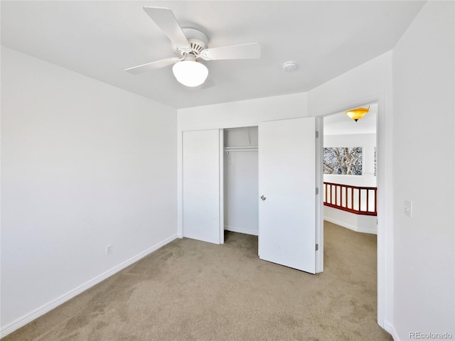 unfurnished bedroom with a closet, carpet flooring, ceiling fan, and baseboards