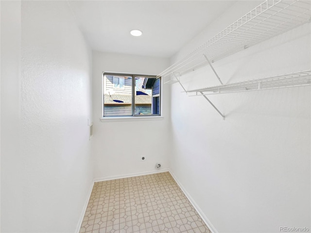 walk in closet with light floors