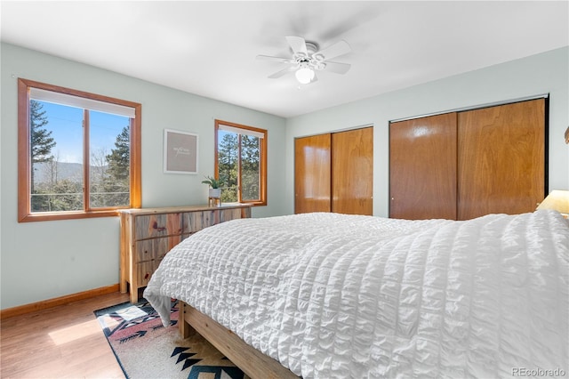 25531 Mosier Cir, Conifer, CO 80433 - bedroom featuring wood finished floors, baseboards, multiple closets, and ceiling fan