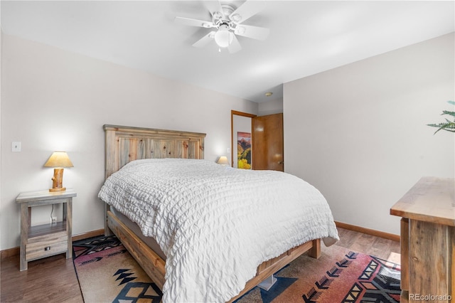 25531 Mosier Cir, Conifer, CO 80433 - bedroom featuring wood finished floors, baseboards, and ceiling fan