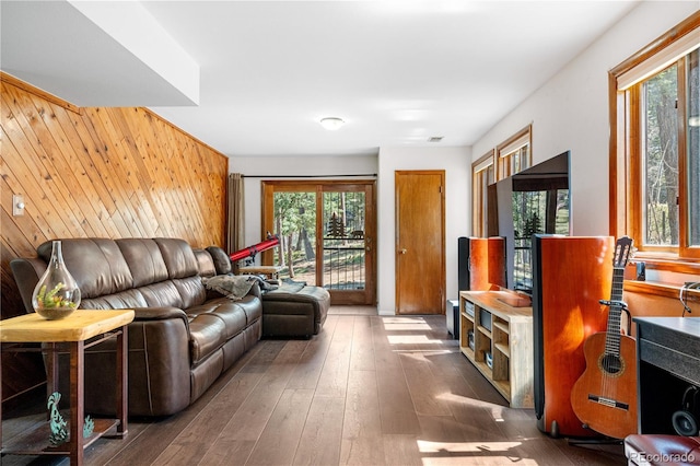 25531 Mosier Cir, Conifer, CO 80433 - living room with healthy amount of natural light, wooden walls, and hardwood / wood-style floors