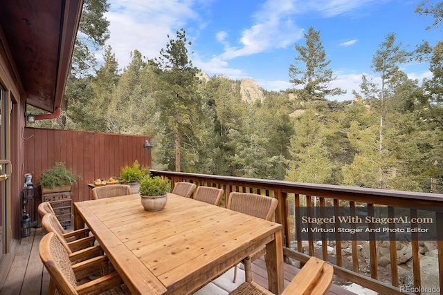 25531 Mosier Cir, Conifer, CO 80433 - deck with outdoor dining area and a forest view