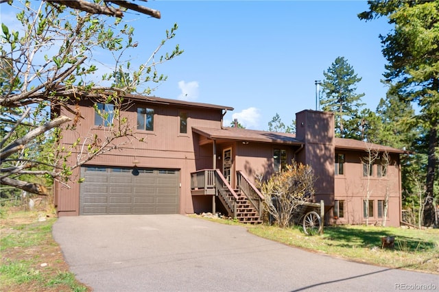 25531 Mosier Cir, Conifer, CO 80433 - view of front of house featuring asphalt driveway and an attached garage