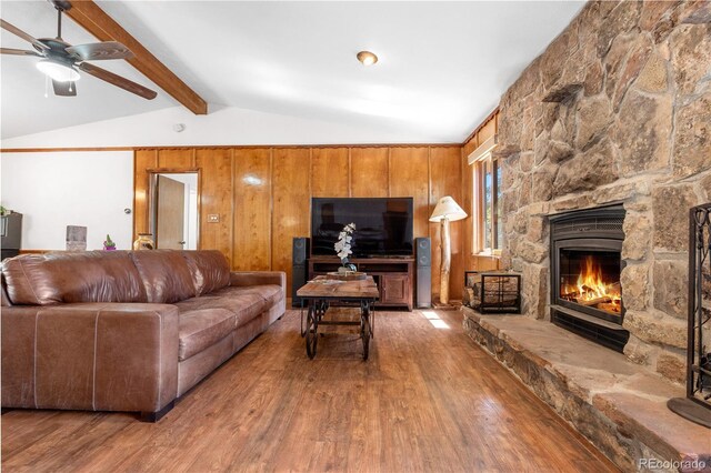 25531 Mosier Cir, Conifer, CO 80433 - living area with wood finished floors, a ceiling fan, and a stone fireplace