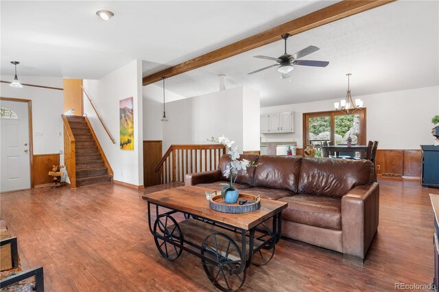 25531 Mosier Cir, Conifer, CO 80433 - living room with wood finished floors, a ceiling fan, stairs, a chandelier, and wainscoting