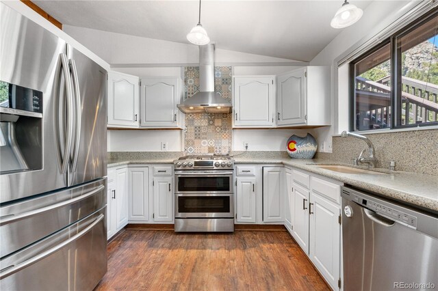 25531 Mosier Cir, Conifer, CO 80433 - kitchen featuring appliances with stainless steel finishes, vaulted ceiling, wall chimney exhaust hood, a sink, and tasteful backsplash