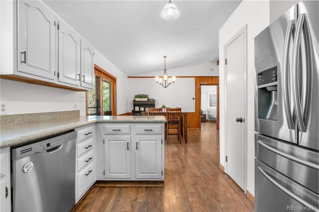 25531 Mosier Cir, Conifer, CO 80433 - kitchen featuring stainless steel appliances, lofted ceiling, dark wood-style floors, white cabinets, and a chandelier