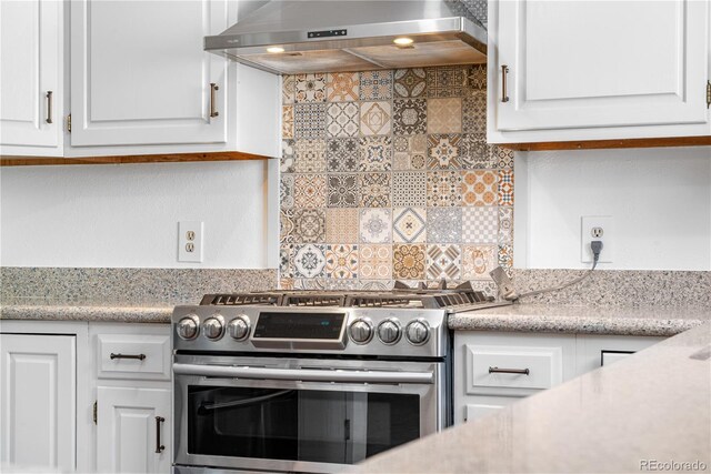 25531 Mosier Cir, Conifer, CO 80433 - kitchen with wall chimney exhaust hood, stainless steel gas range oven, light countertops, and white cabinets