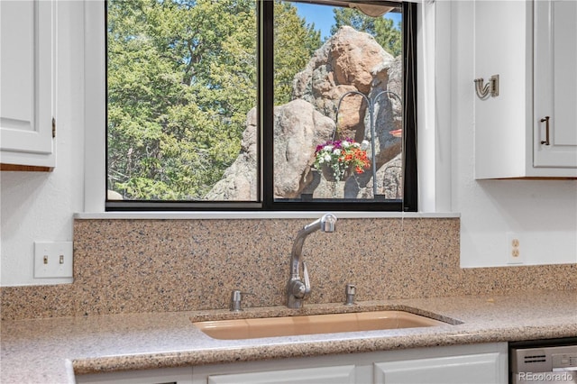25531 Mosier Cir, Conifer, CO 80433 - detailed view of a sink, dishwashing machine, tasteful backsplash, and white cabinets